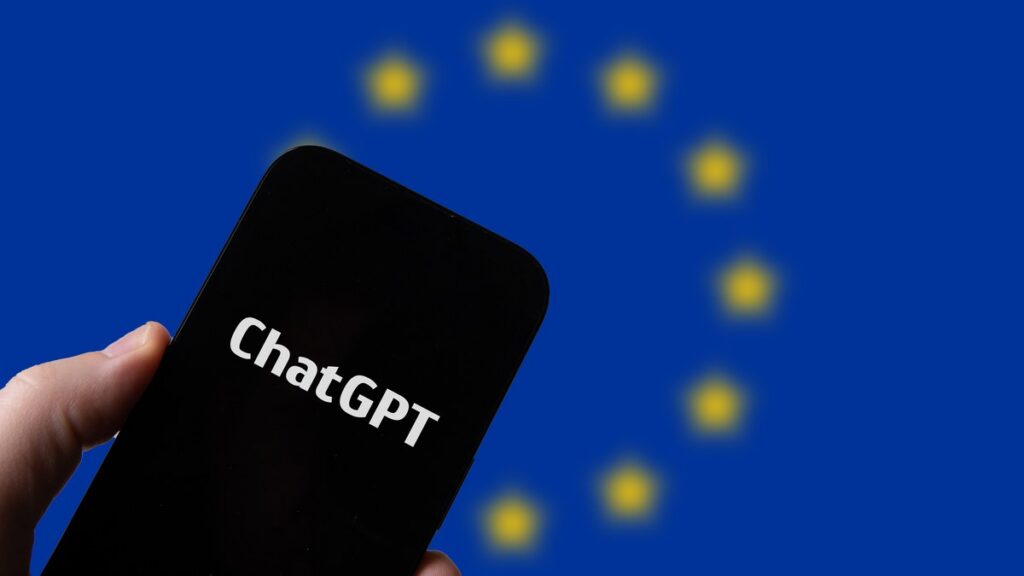 ChatGPT sur smartphone devant le drapeau de l’Union européenne